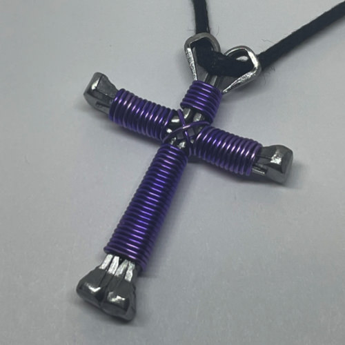 Nail cross necklace wrapped with bold amethyst wire.