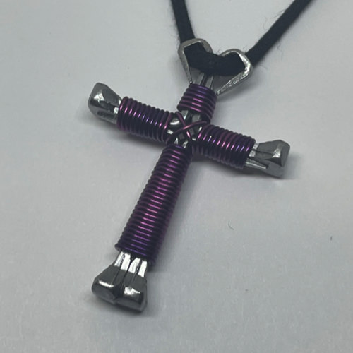 A small black cross of nails necklace on a black cord.