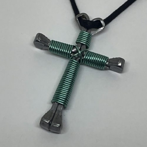 A horseshoe nail cross necklace wrapped with thin baby wire