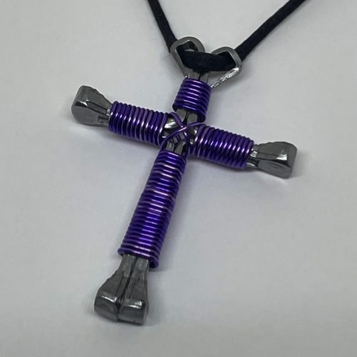 A horseshoe nail cross necklace wrapped with thin lavender wire