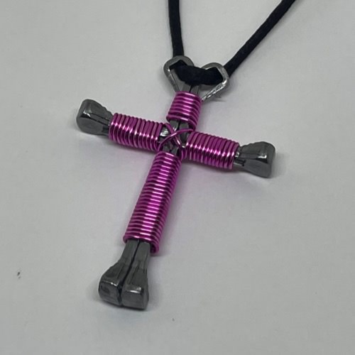 Pink Horseshoe Nail Cross Necklace on a black cord.