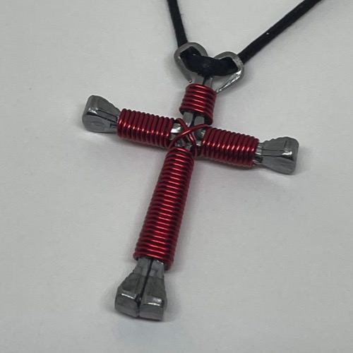 A horseshoe nail cross wrapped with thin red wire