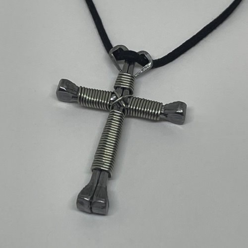 A horseshoe nail cross necklace wrapped with thin silver wire